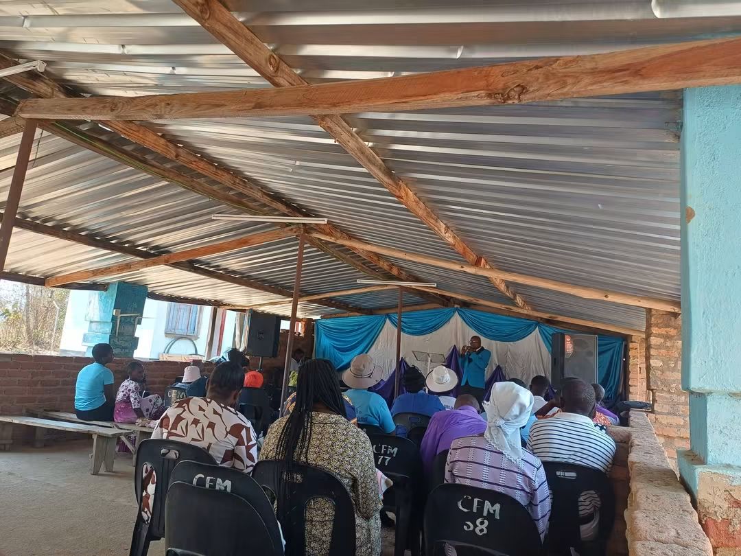 CFM congregation gathered under the church shelter