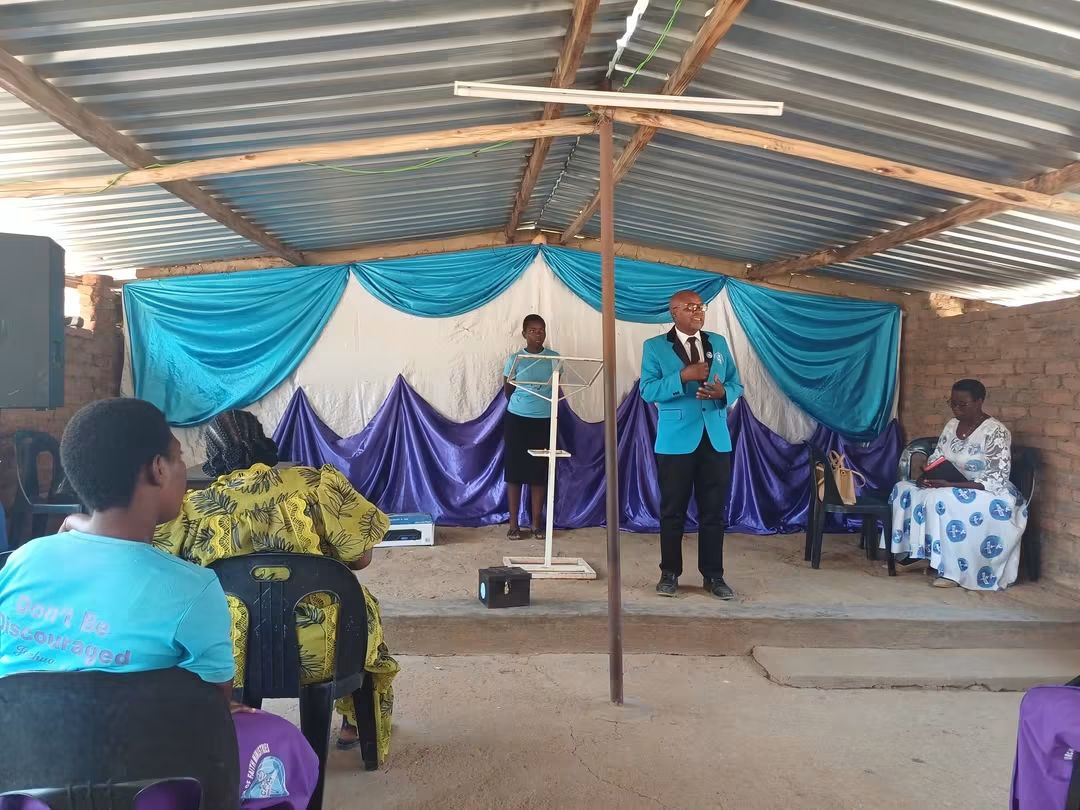 A CFM minister preaching from the front of the church